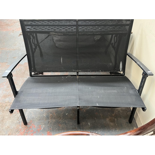 881 - A metal folding two seater garden bench