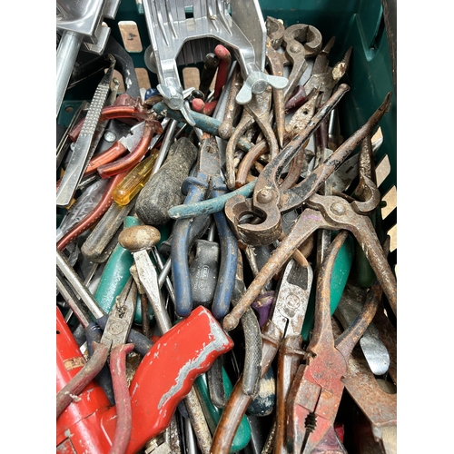 923 - A collection of tools to include bench vice, tin snips, wood planes etc.