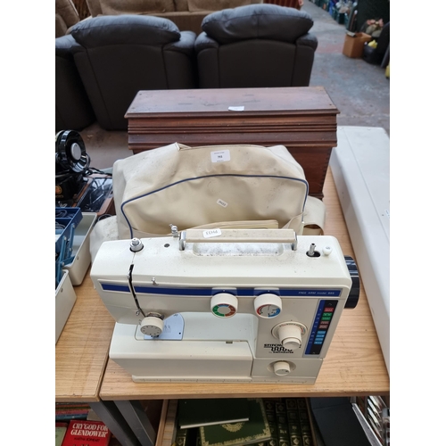 793 - A cased Knitmaster Stitchmaster 885 electric sewing machine with foot pedal, accessories and instruc... 