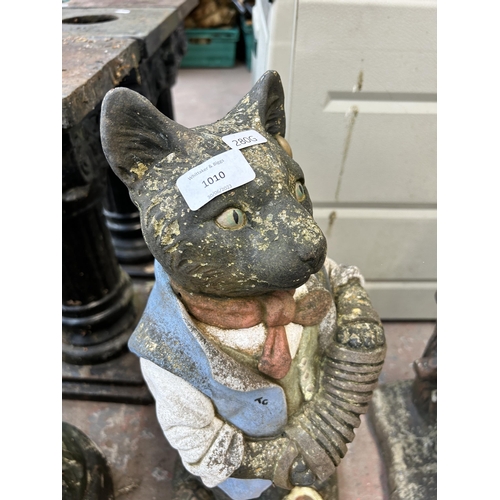 1010 - A cast stone figural garden ornament in the form of a cat with concertina