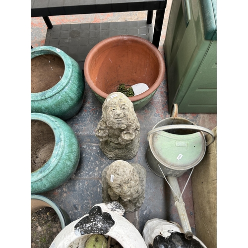 993 - Eight garden items, one terracotta planter, one galvanised watering can and six cast stone and fibre... 