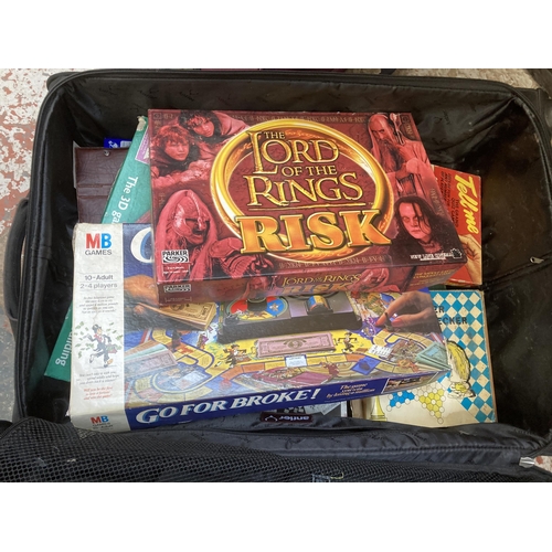 1032 - Two travel cases containing vinyl records, cassette tapes and board games