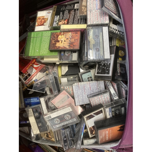 1032 - Two travel cases containing vinyl records, cassette tapes and board games