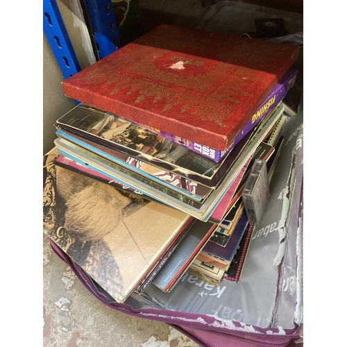 1032 - Two travel cases containing vinyl records, cassette tapes and board games