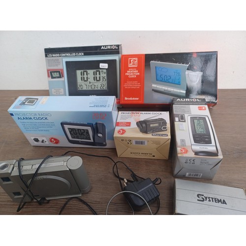 696 - Seven items to include boxed LCD radio controlled clock, boxed wireless weather projection clock, bo... 