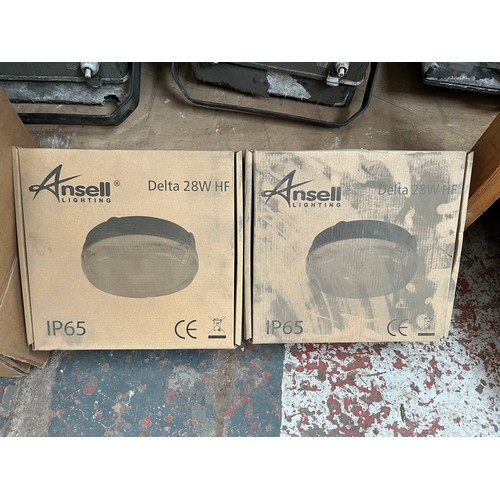 1020A - A collection of new and used flood lights to include two boxed Ansell Delta TC-DD etc.