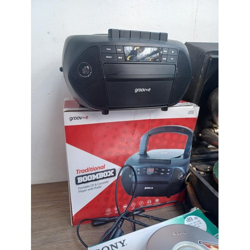 708 - A collection of items to include boxed Sony D-EJ119 Walkman CD player, Goodmans CD player, boxed Gro... 