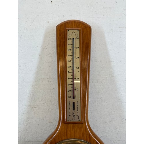 634 - Two items, one oak cased quartz mantel clock and one J. D. Siddall wooden cased barometer