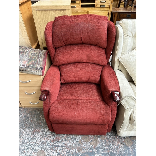 91 - A red fabric upholstered reclining armchair