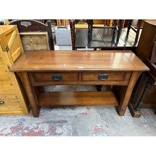 97 - An Arts & Crafts style oak two drawer console table - approx. 72cm high x 127cm wide x 46cm deep