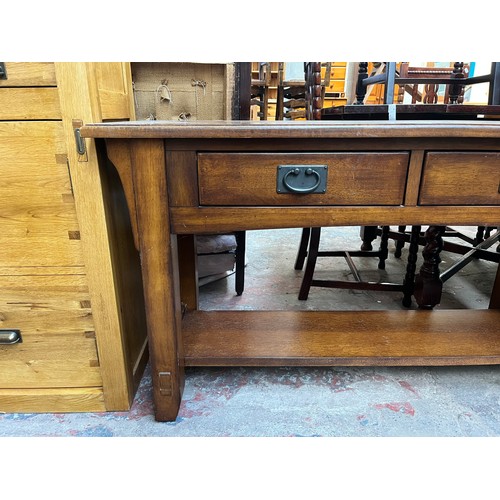 97 - An Arts & Crafts style oak two drawer console table - approx. 72cm high x 127cm wide x 46cm deep