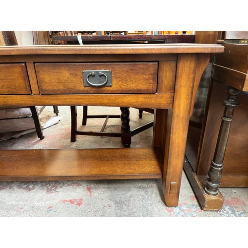 97 - An Arts & Crafts style oak two drawer console table - approx. 72cm high x 127cm wide x 46cm deep