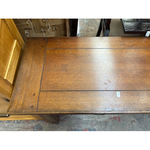 97 - An Arts & Crafts style oak two drawer console table - approx. 72cm high x 127cm wide x 46cm deep