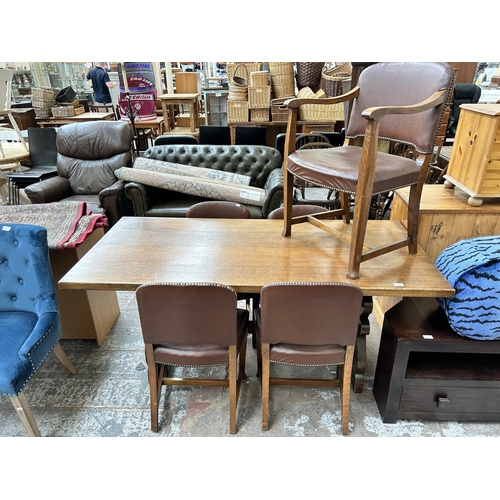 105 - An oak rectangular trestle dining table and five brown leatherette dining chairs