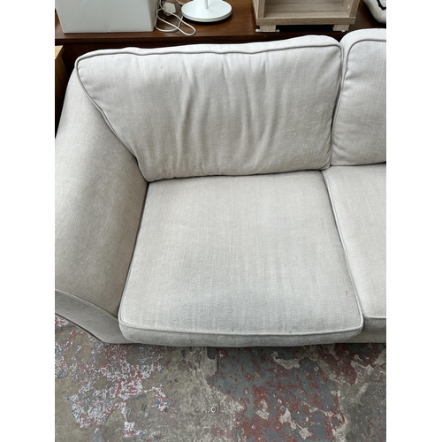 110 - A Waring & Gillow fabric upholstered three seater sofa