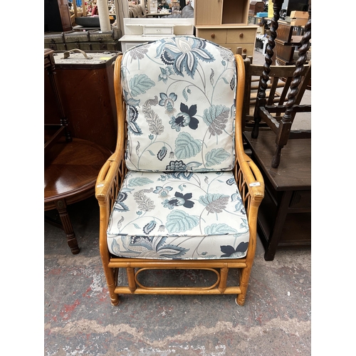 126 - A bamboo and wicker conservatory armchair with floral upholstery