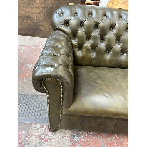 139 - A 1930s green leather Chesterfield drop arm sofa