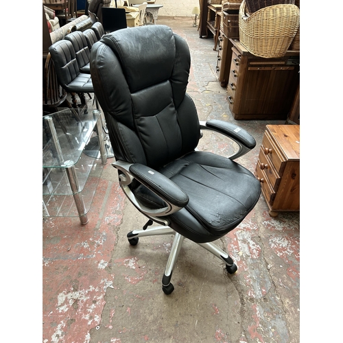 141 - A black leatherette and grey plastic swivel office desk chair