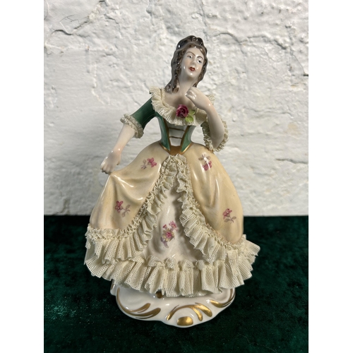 284 - A Dresden hand painted lace porcelain lady figurine, numbered 527 - approx. 17cm high