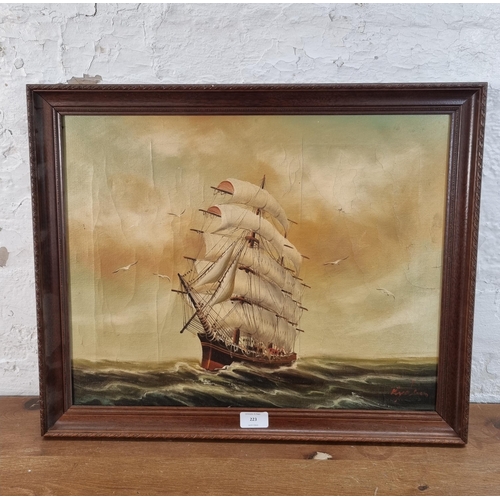 223 - A framed oil on canvas of a sailing ship signed lower right - approx. 47cm high x 57cm wide