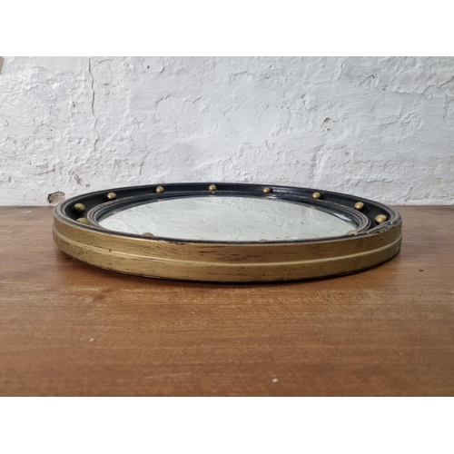 230 - A Regency style ebonised and gilt framed convex wall mirror - approx. 37cm diameter