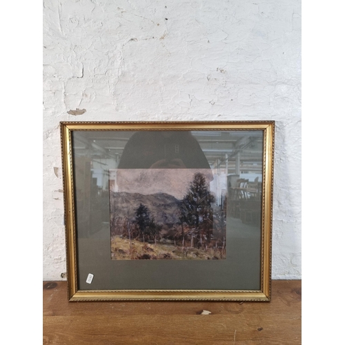 242 - A gilt framed watercolour of a landscape scene signed lower left - approx. 45cm high x 51cm wide