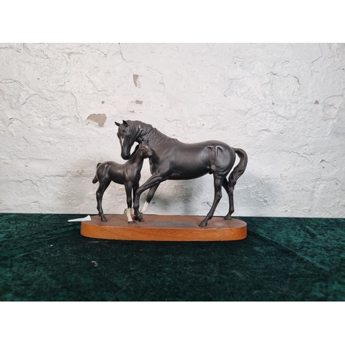 268 - A Beswick Connoisseur model of Black Beauty and Foal on mahogany plinth - approx. 20cm high