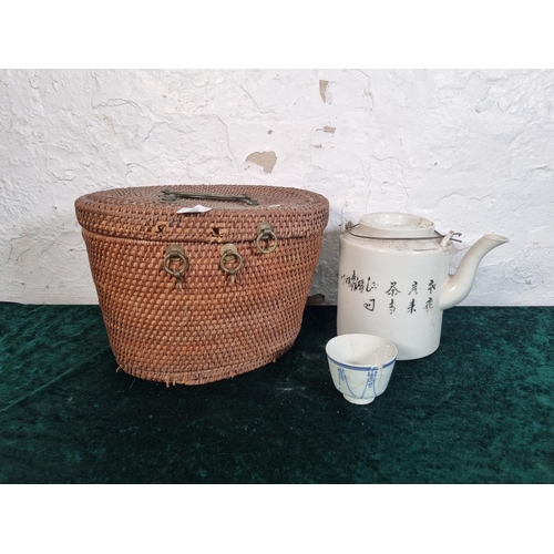 269 - A Chinese republic period porcelain teapot with cup and wicker basket