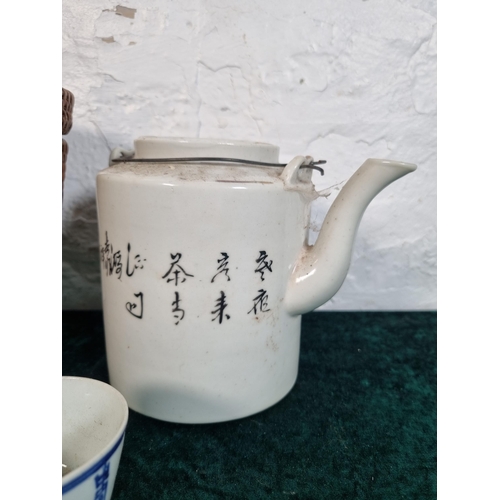 269 - A Chinese republic period porcelain teapot with cup and wicker basket