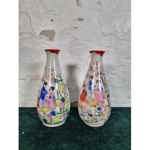 270 - A pair of Oriental hand painted porcelain vases - approx. 17cm high