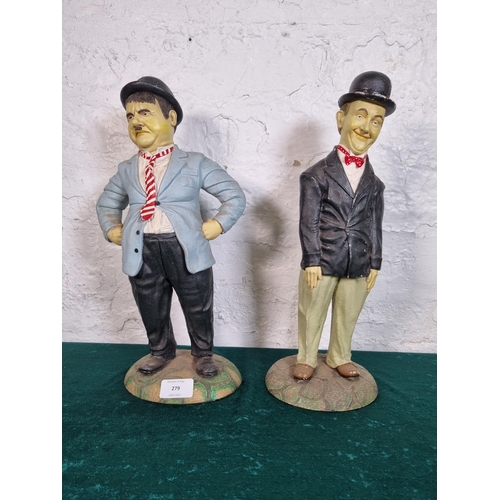 279 - A pair of Peter Mook Laurel and Hardy resin figurines - largest approx. 37cm high