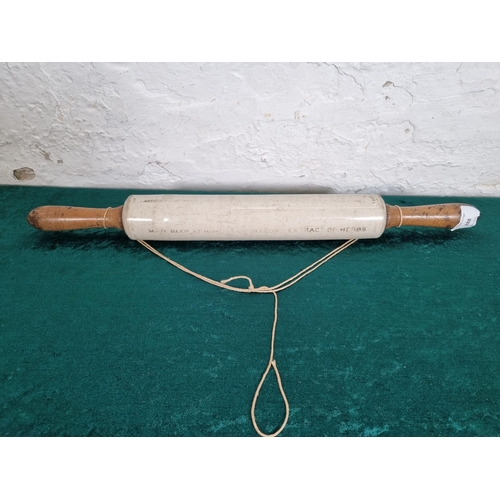 288 - A 1920s Isobel ceramic and boxwood rolling pin - approx. 50cm long