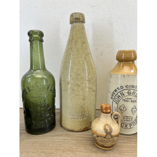 300 - Seven early 20th century stoneware and glass bottles to include J. Lawson Buxton, H. Clarke Stockpor... 