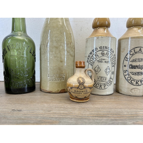 300 - Seven early 20th century stoneware and glass bottles to include J. Lawson Buxton, H. Clarke Stockpor... 