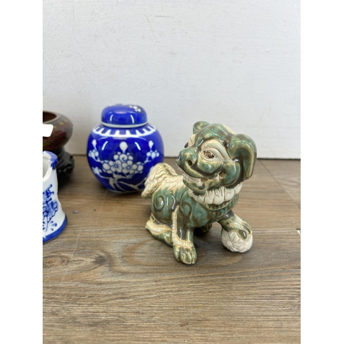 327 - A collection of Oriental items to include Prunus Blossom ginger jar and cover, pair of foo dog figur... 