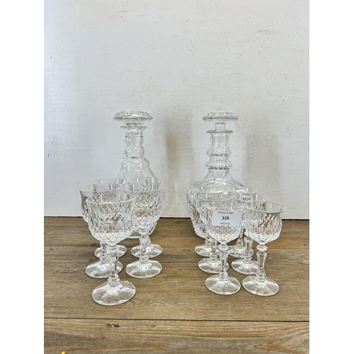 328 - A collection of cut glassware to include two decanters etc.