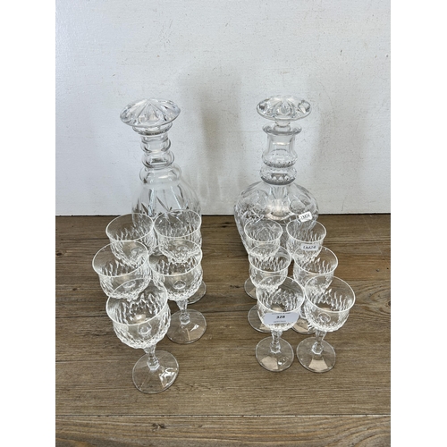 328 - A collection of cut glassware to include two decanters etc.