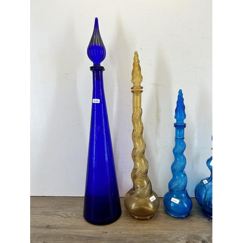 339 - Four 1960s Empoli glass genie bottles - largest approx. 66cm high