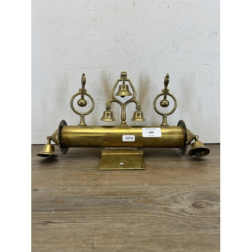 360 - A late 19th/early 20th century brass sleigh mount with five bells and two rotating finials in the fo... 