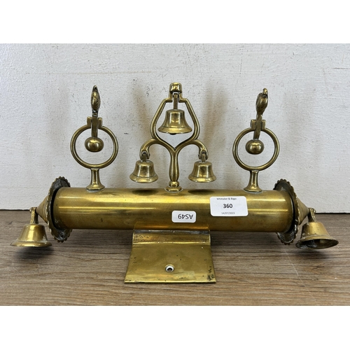 360 - A late 19th/early 20th century brass sleigh mount with five bells and two rotating finials in the fo... 