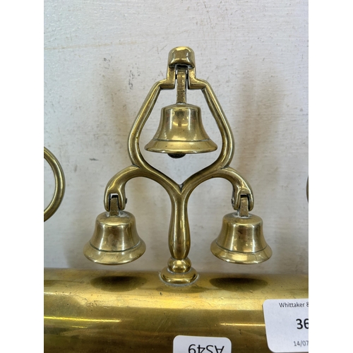 360 - A late 19th/early 20th century brass sleigh mount with five bells and two rotating finials in the fo... 