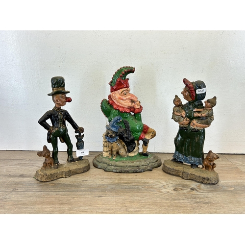 378 - Three late 19th/early 20th century cast iron Punch & Judy door stops - largest approx. 31cm high