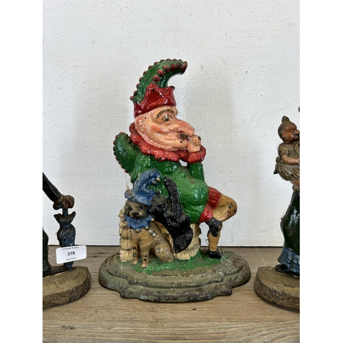 378 - Three late 19th/early 20th century cast iron Punch & Judy door stops - largest approx. 31cm high