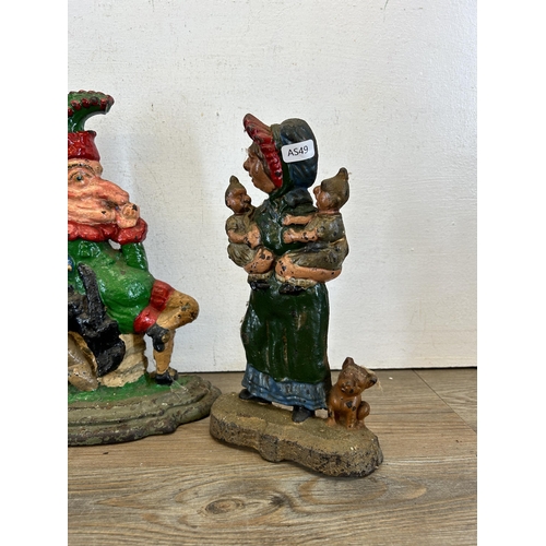 378 - Three late 19th/early 20th century cast iron Punch & Judy door stops - largest approx. 31cm high