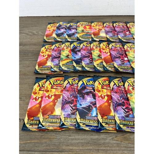 384 - Approx. thirty six packaged and unopened Pokémon Sword & Shield Darkness Ablaze trading cards