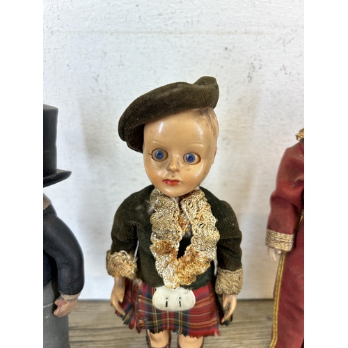 385 - A collection of vintage children's toys to include Beefeater Queens Guards, Clockwork bird etc.