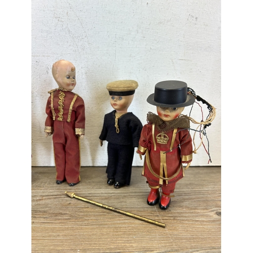 385 - A collection of vintage children's toys to include Beefeater Queens Guards, Clockwork bird etc.