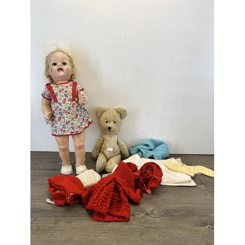 389 - Three items, one 1950s plastic mechanical walking doll, one articulated teddy bear and a collection ... 