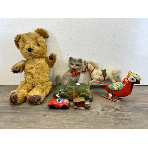 393 - A collection of vintage toys to include three clockwork soft toys, two clockwork tin plate and two m... 