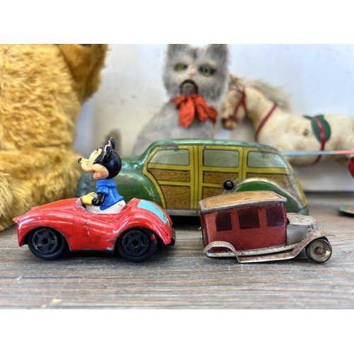 393 - A collection of vintage toys to include three clockwork soft toys, two clockwork tin plate and two m... 